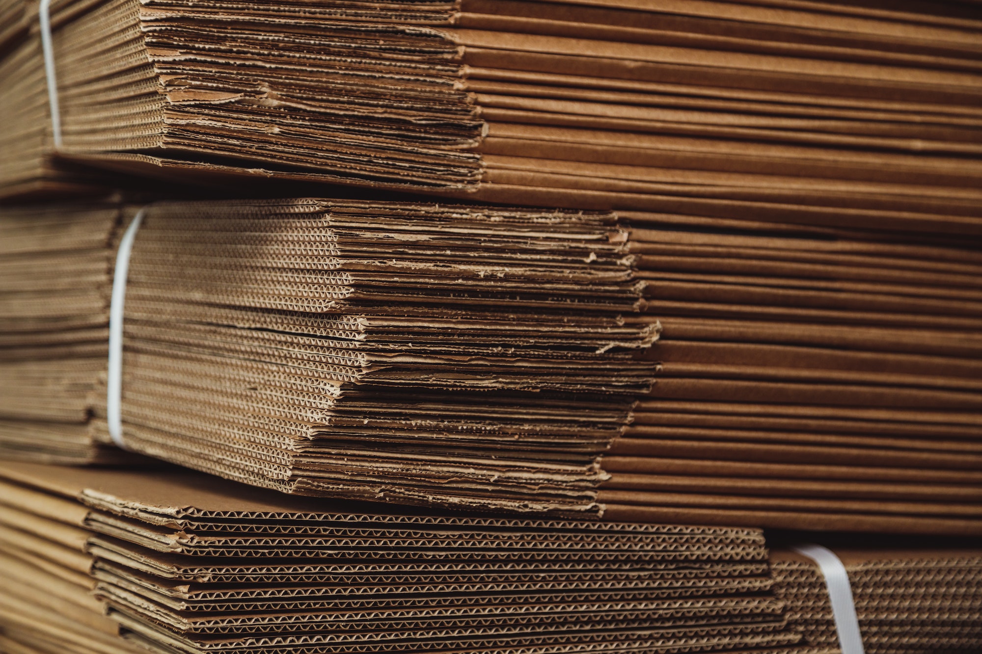 corrugated cardboard for packing, Pile of corrugated cardboard sheets in warehouse